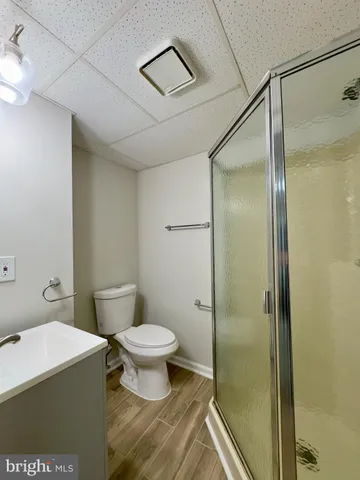 a bathroom with a toilet and a shower