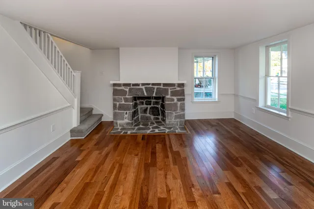 a view of a livingroom with wooden floor and furniture
