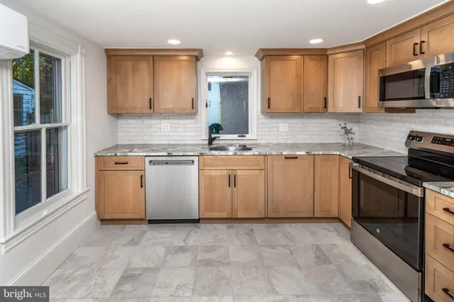 a kitchen with a stove sink and microwave