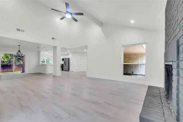 a large kitchen with a lot of counter space and wooden floor