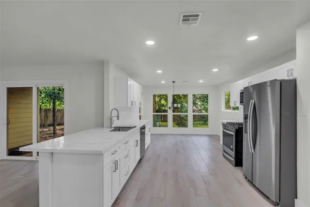 a living room with a bed furniture and a large window