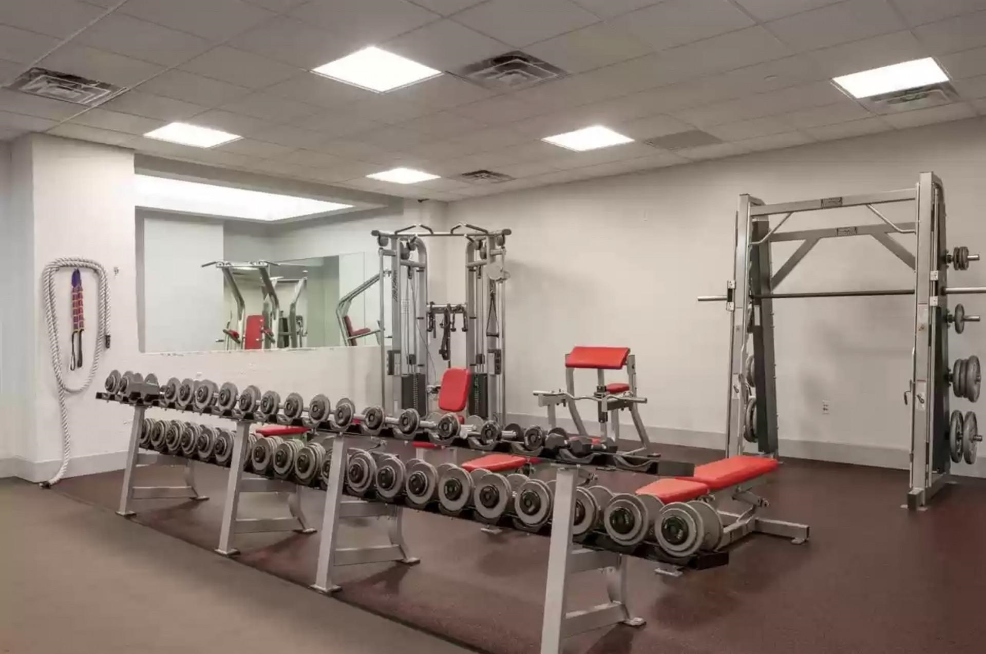 50 Dey Street, Unit 259 Jersey City, NJ 07306 - Photo 17 of 24 a room with gym equipment and mirrors
