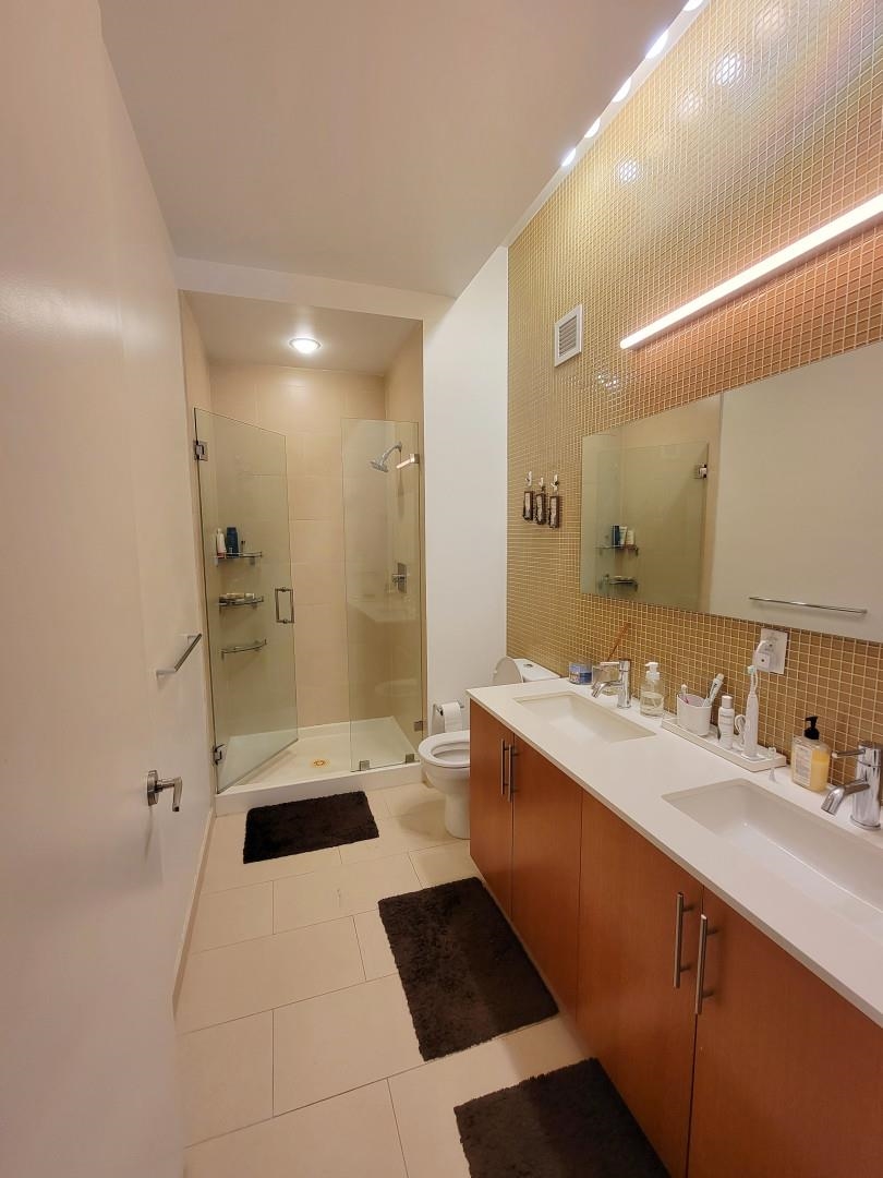 50 Dey Street, Unit 259 Jersey City, NJ 07306 - Photo 9 of 24 a bathroom with a sink a toilet and shower
