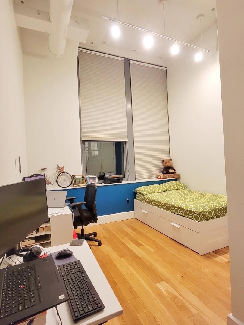 50 Dey Street, Unit 259 Jersey City, NJ 07306 - Photo 10 of 24 a bedroom with a bed and a desk