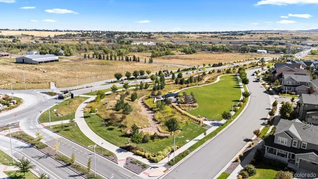 a view of an empty room with wooden floor and closet
