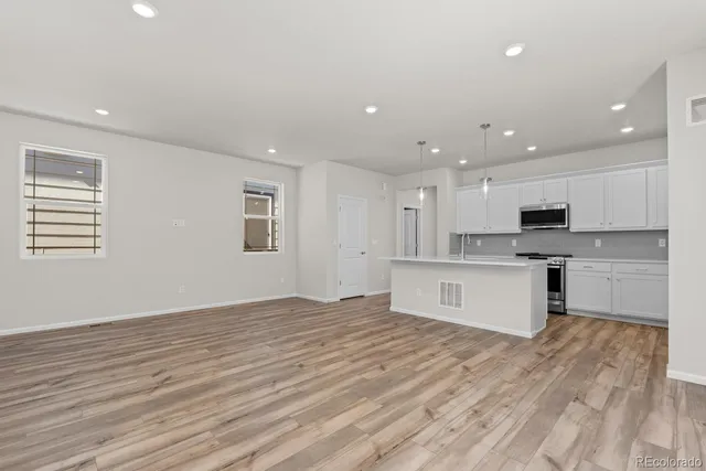 a kitchen with stainless steel appliances granite countertop a sink and a stove