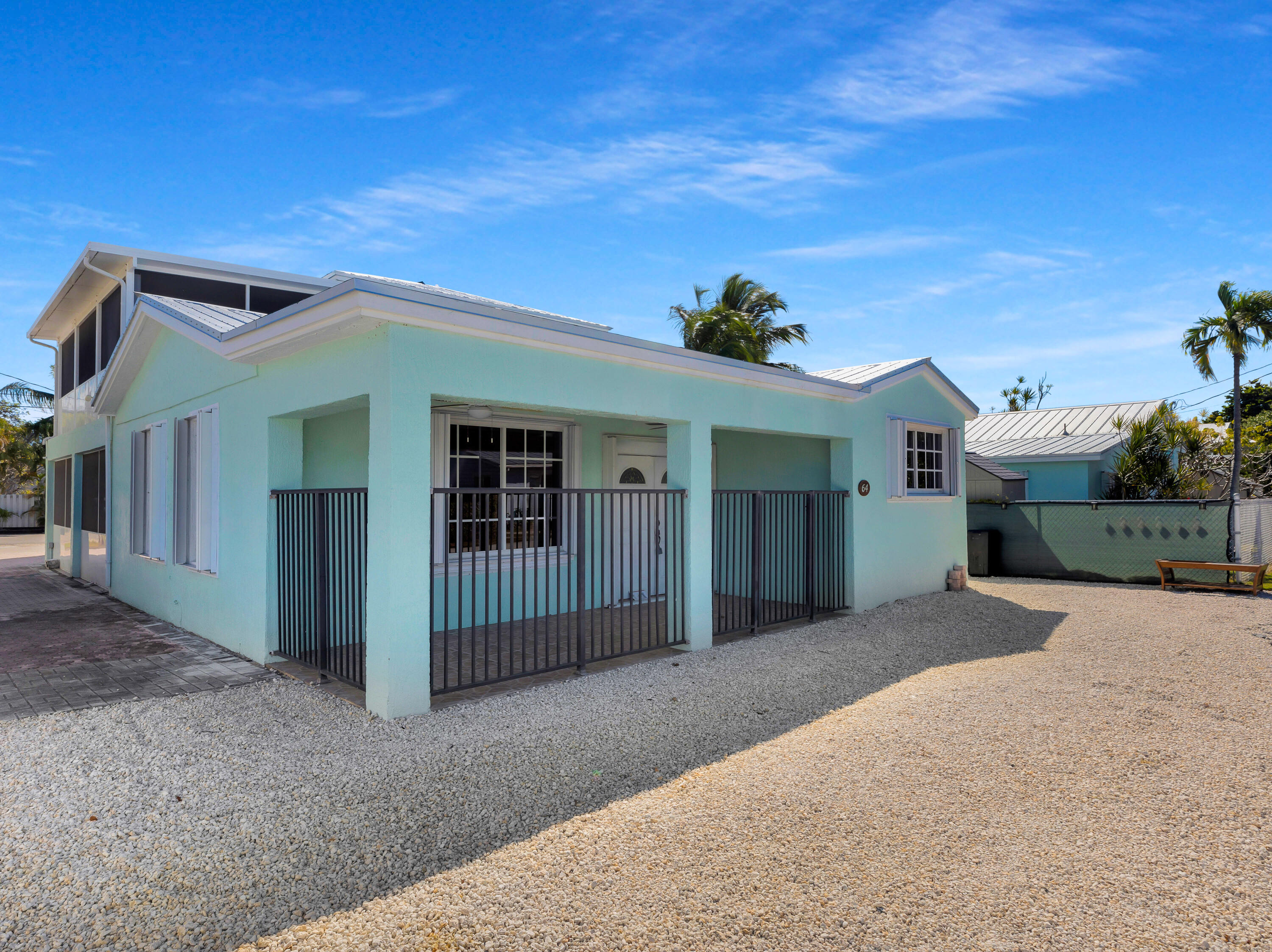 64 Coconut Drive Key Largo, FL 33037 - Photo 2 of 54 a front view of a house with a porch