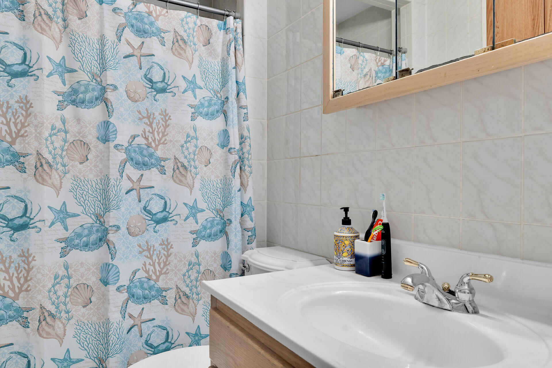 64 Coconut Drive Key Largo, FL 33037 - Photo 23 of 54 a bathroom with a sink and a mirror