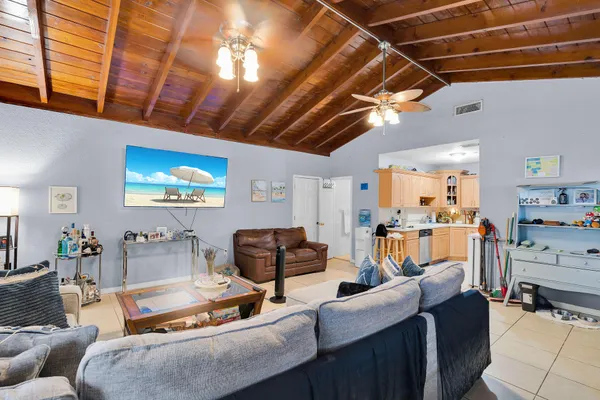 a living room with furniture and kitchen view