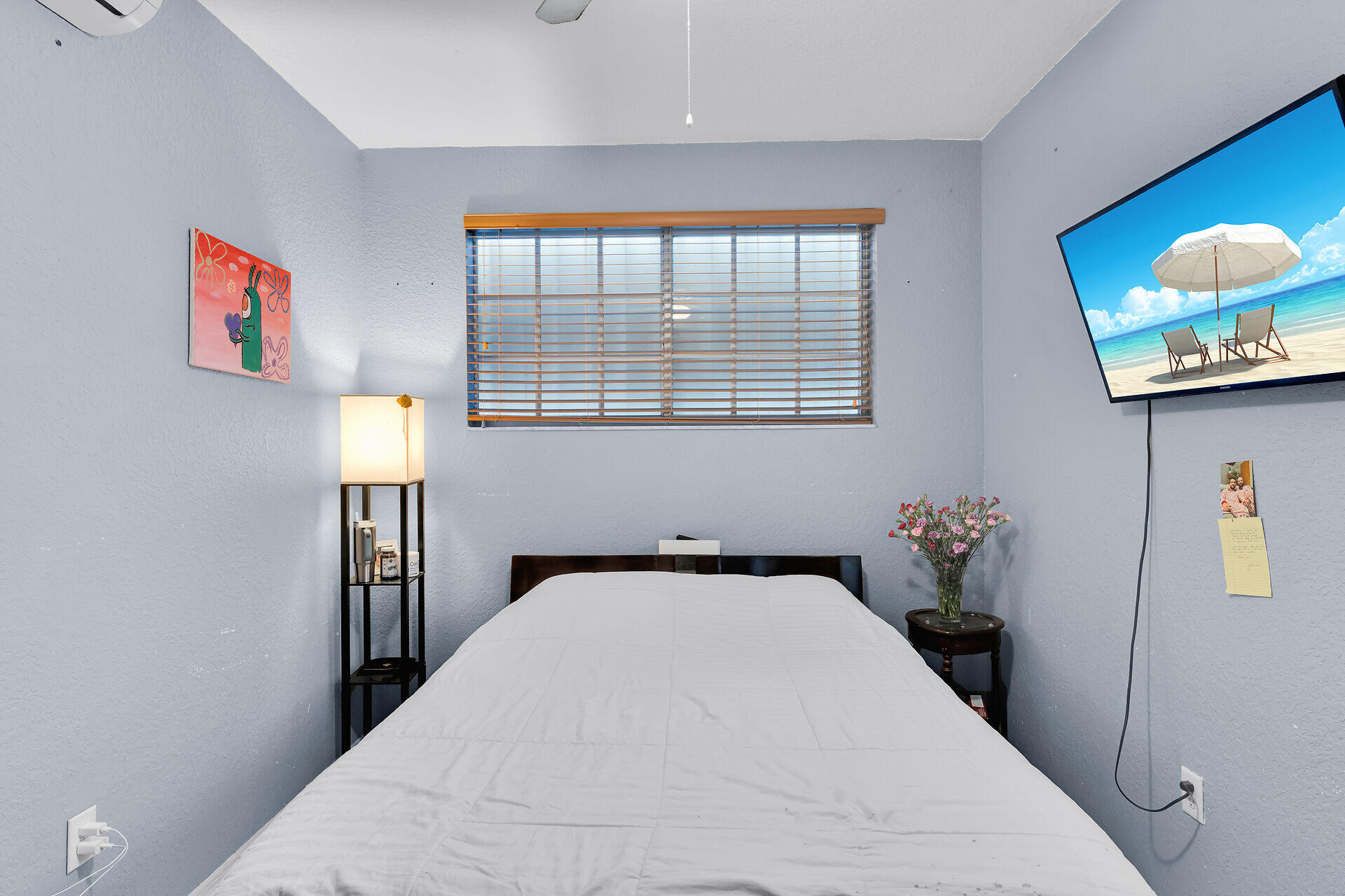 64 Coconut Drive Key Largo, FL 33037 - Photo 31 of 54 a bedroom with a bed and a painting on the wall