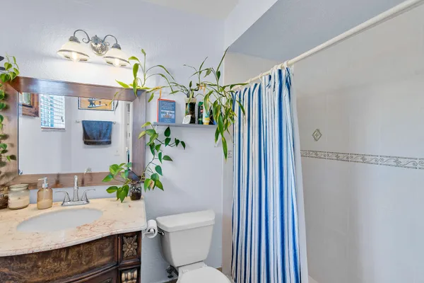 a view of a dining room with a table and chairs