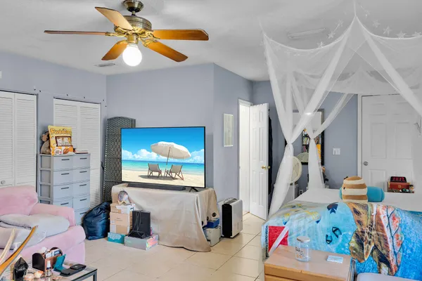 a bedroom with a bed and a dining table with painted walls