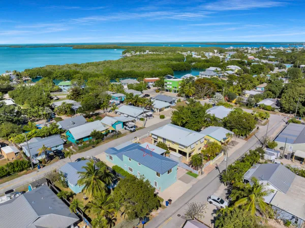 an aerial view of residential houses with outdoor space