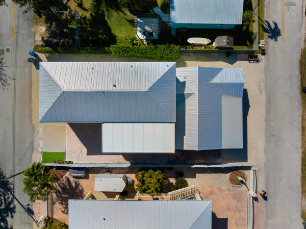 an aerial view of a house with roof deck and furniture