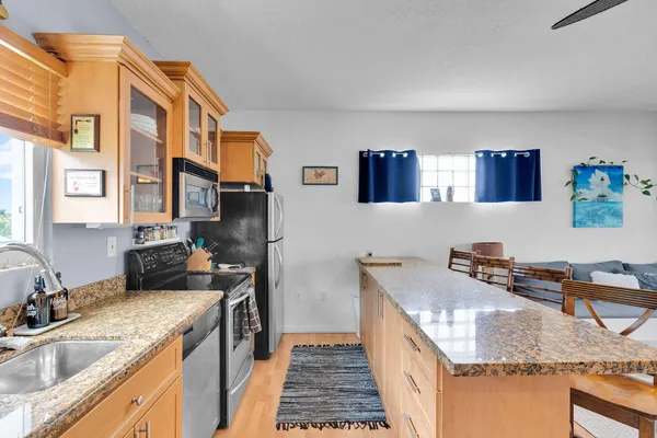a kitchen with stainless steel appliances granite countertop a sink and cabinets