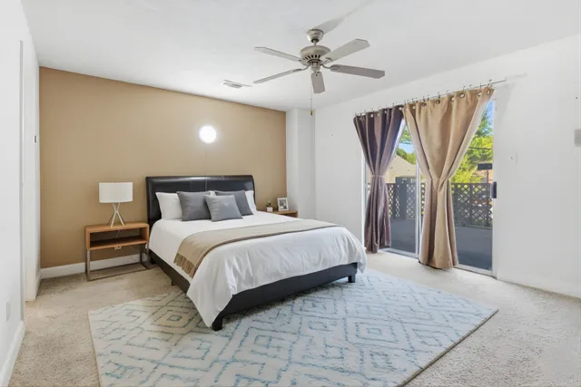 a bedroom with a large bed and a chandelier