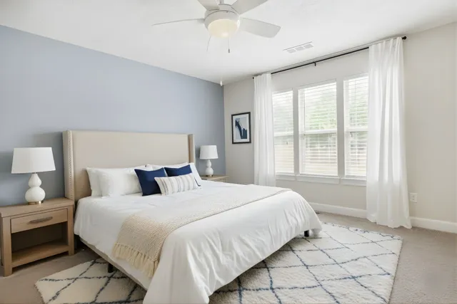 a bedroom with a bed and a large window