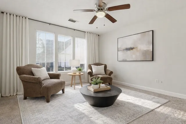 a living room with furniture and a large window