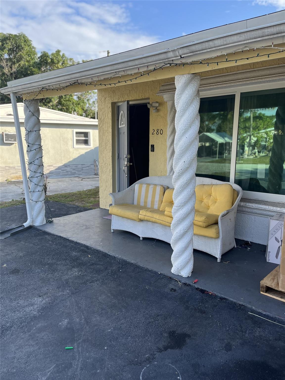 a backyard of a house with barbeque oven table and chairs