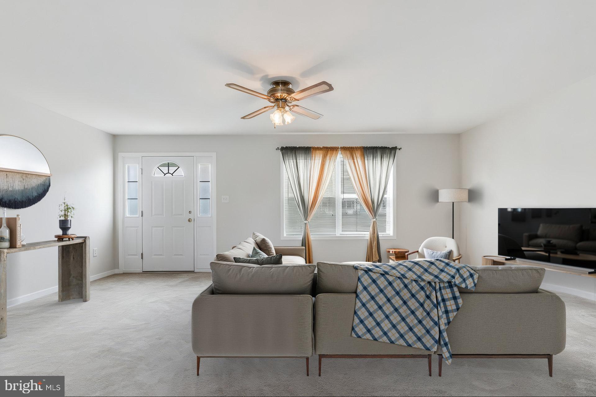 30147 Regatta Bay Boulevard Lewes, DE 19958 - Photo 27 of 74 a living room with furniture a flat screen tv and a large window