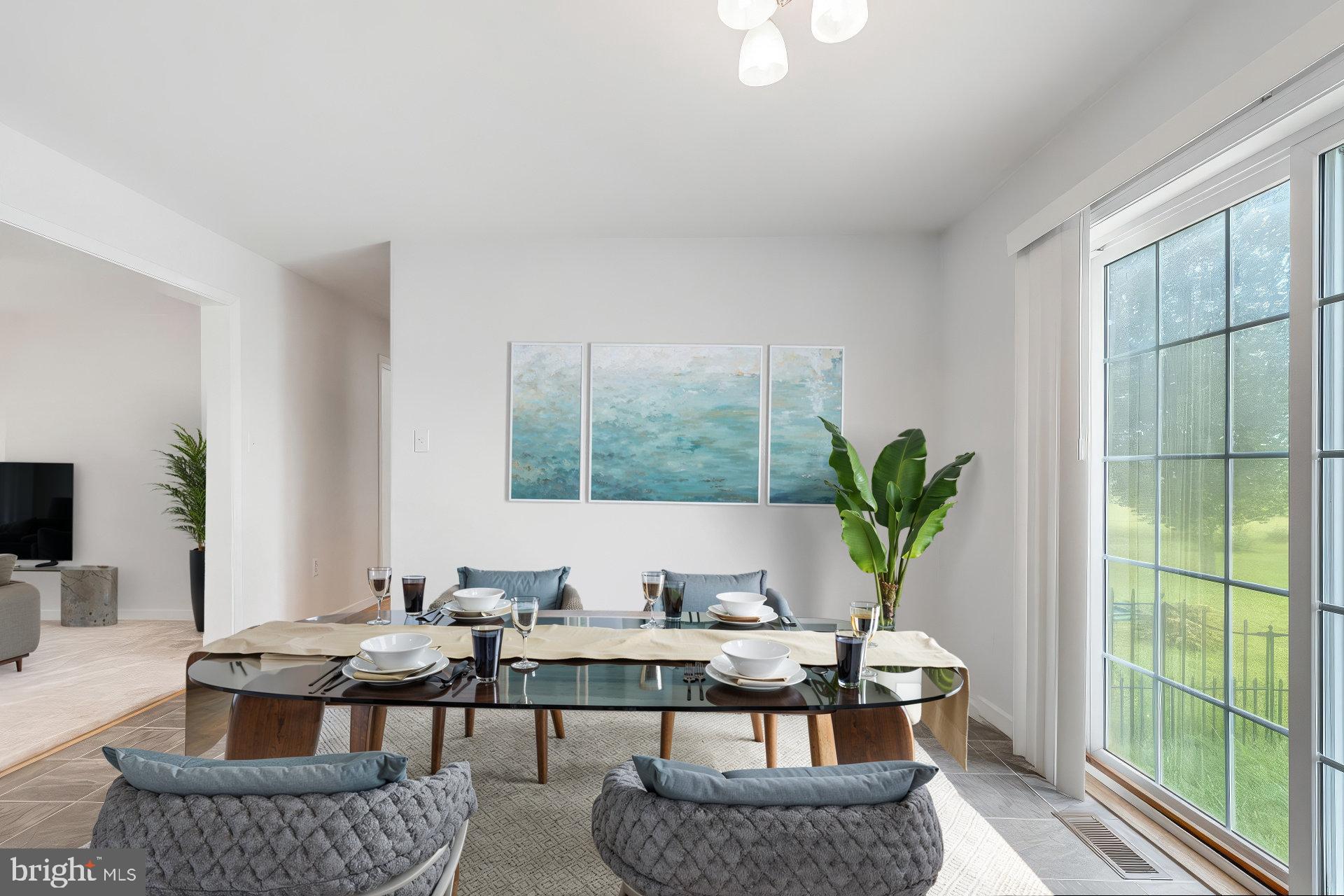 30147 Regatta Bay Boulevard Lewes, DE 19958 - Photo 35 of 74 a living room with furniture a large window and a potted plant