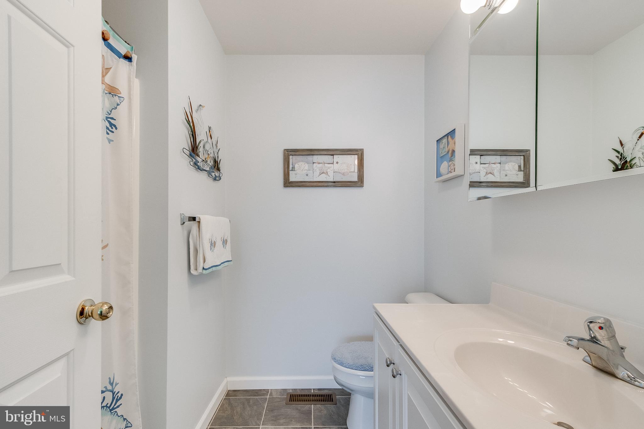30147 Regatta Bay Boulevard Lewes, DE 19958 - Photo 50 of 74 a bathroom with a sink toilet and vanity