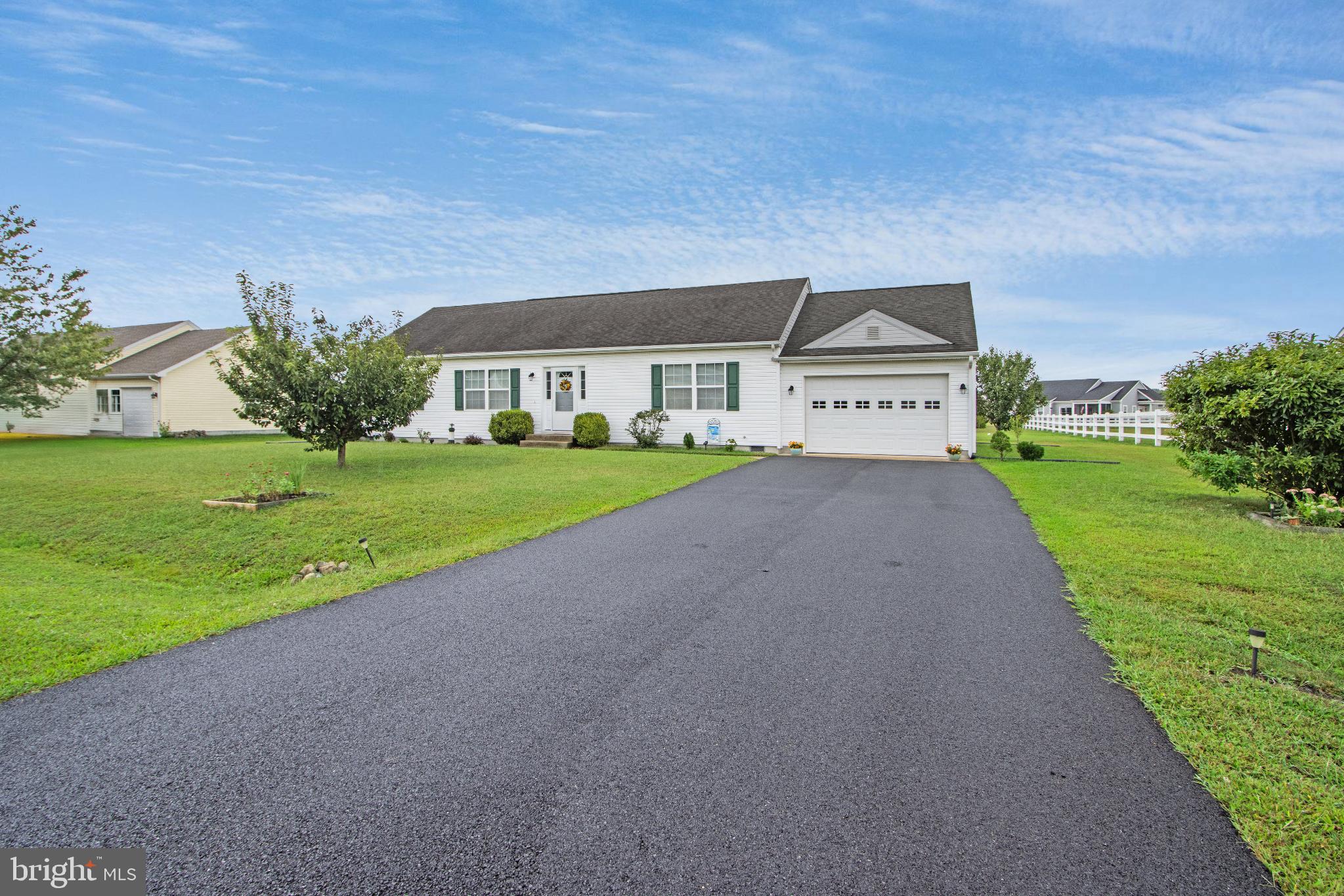 30147 Regatta Bay Boulevard Lewes, DE 19958 - Photo 5 of 74 a front view of a house with a yard and garage