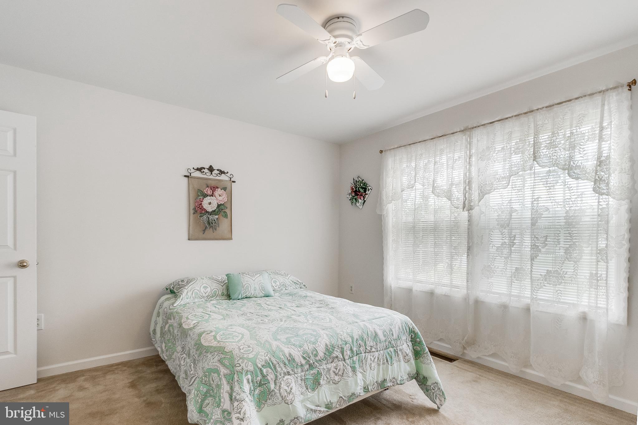 30147 Regatta Bay Boulevard Lewes, DE 19958 - Photo 51 of 74 a bedroom with a bed and a window