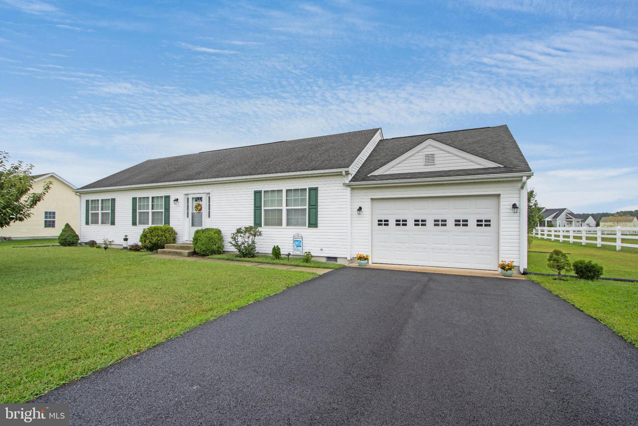 30147 Regatta Bay Boulevard Lewes, DE 19958 - Photo 9 of 74 a view of a house with a yard and garage