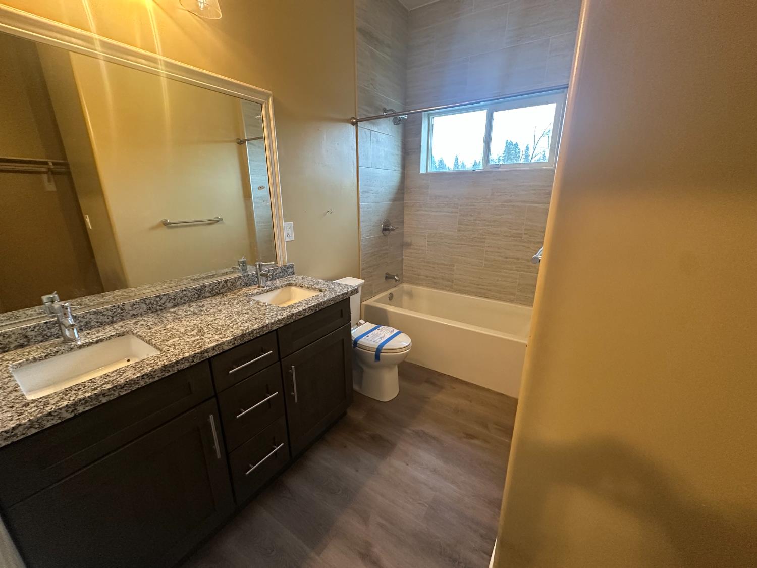 102 Shadow Wood Place Colfax, CA 95713 - Photo 11 of 15 a bathroom with a granite countertop sink a toilet and shower