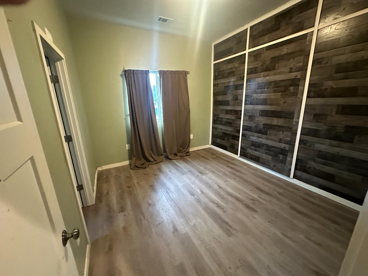 102 Shadow Wood Place Colfax, CA 95713 - Photo 7 of 15 a view of an empty room with wooden floor and a window