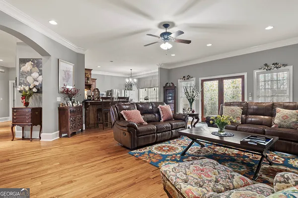 a living room with furniture and wooden floor