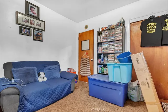 a living room with furniture and a book shelf