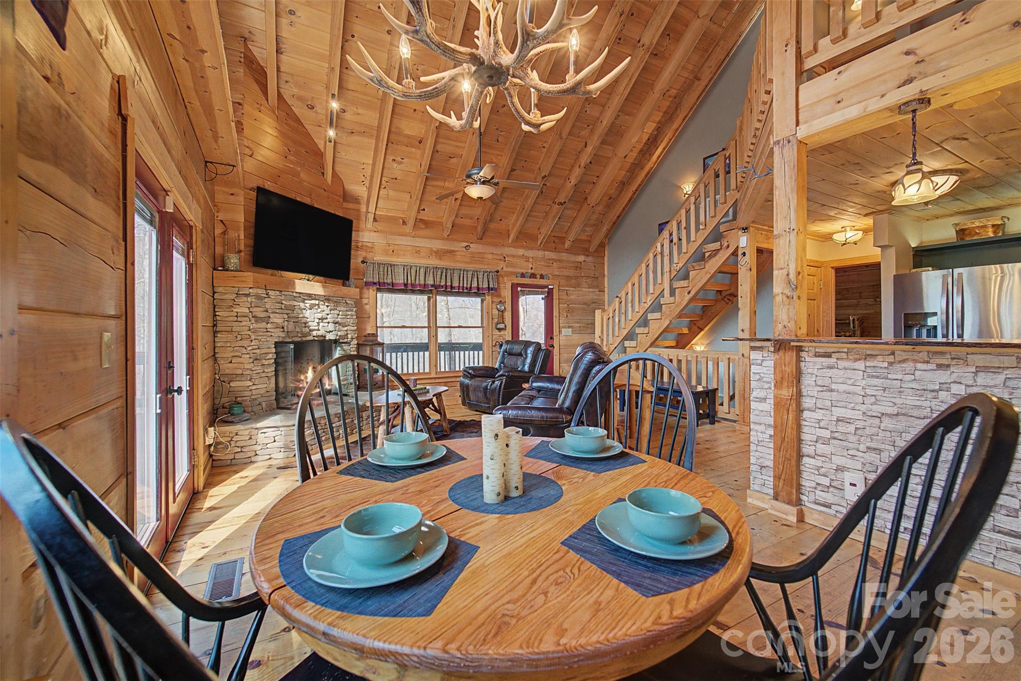 170 Wilkes Road Bryson City, NC 28713 - Photo 11 of 47 a view of a dining room with furniture a rug and wooden floor