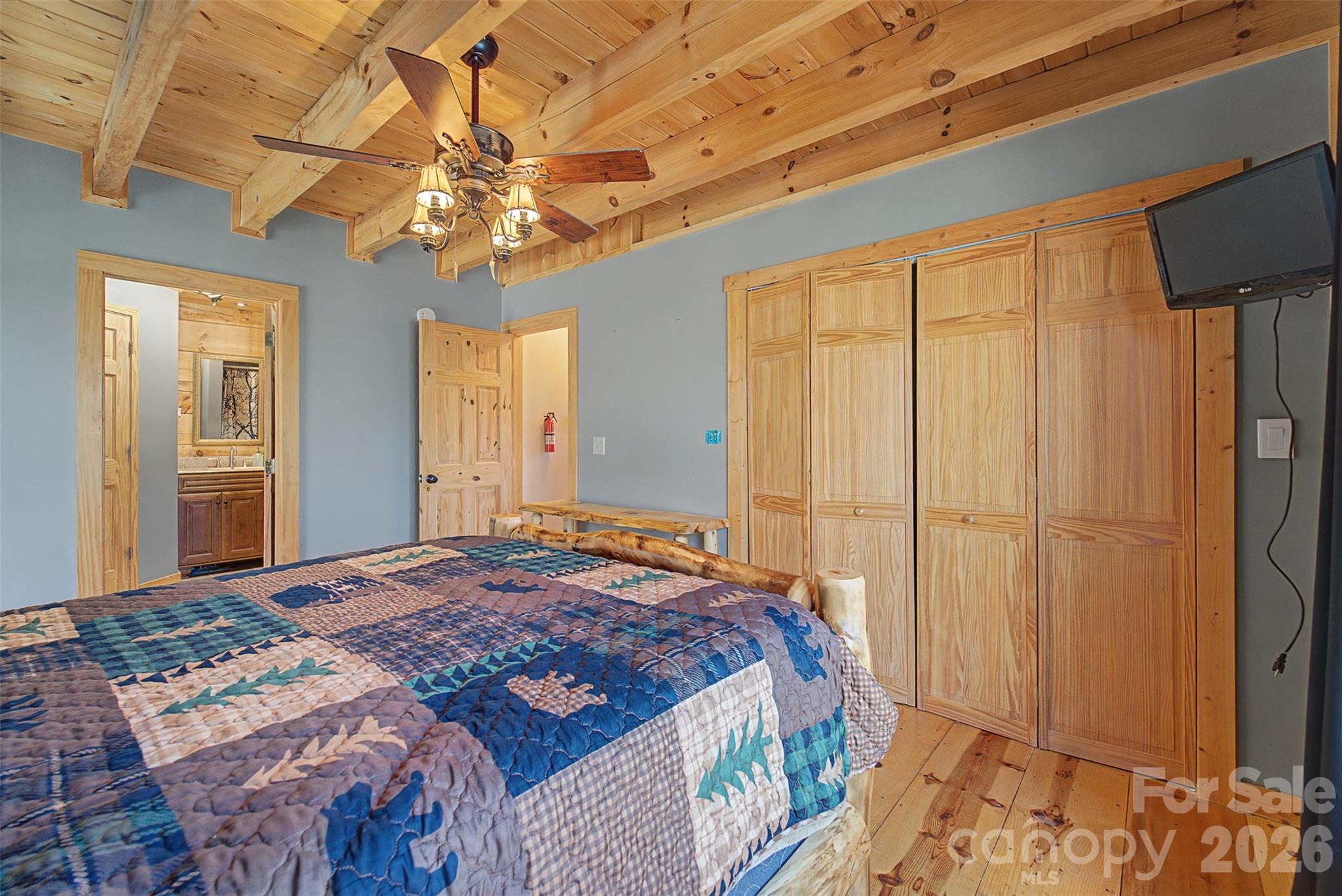 170 Wilkes Road Bryson City, NC 28713 - Photo 17 of 47 a bedroom with a bed and a chandelier