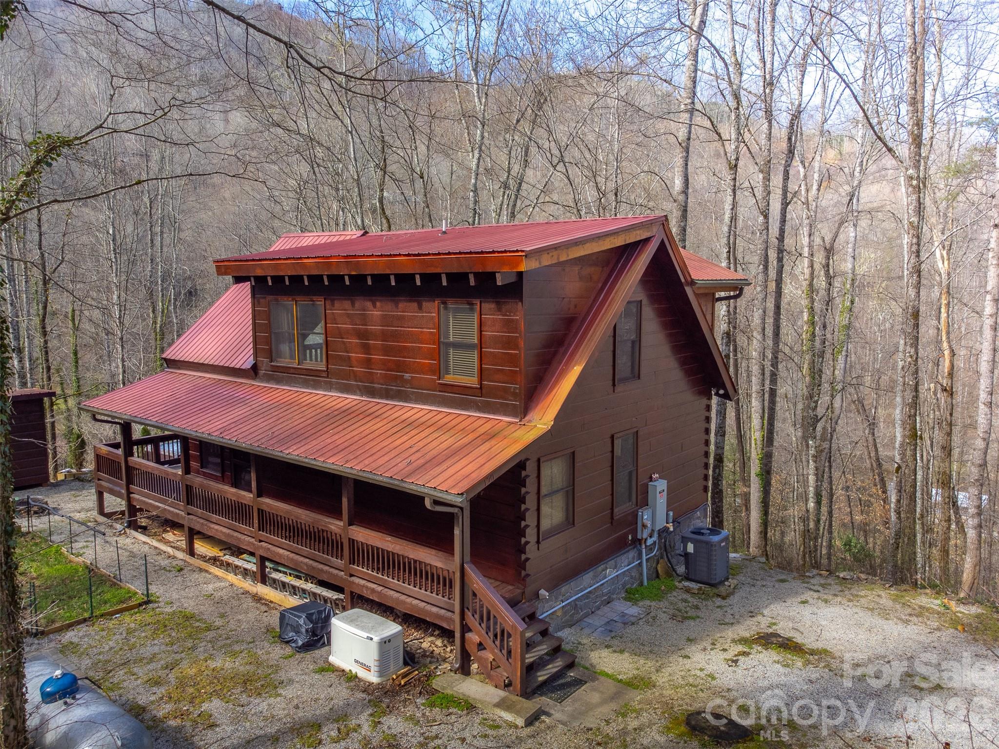 170 Wilkes Road Bryson City, NC 28713 - Photo 2 of 47 a backyard of a house with a table and chairs