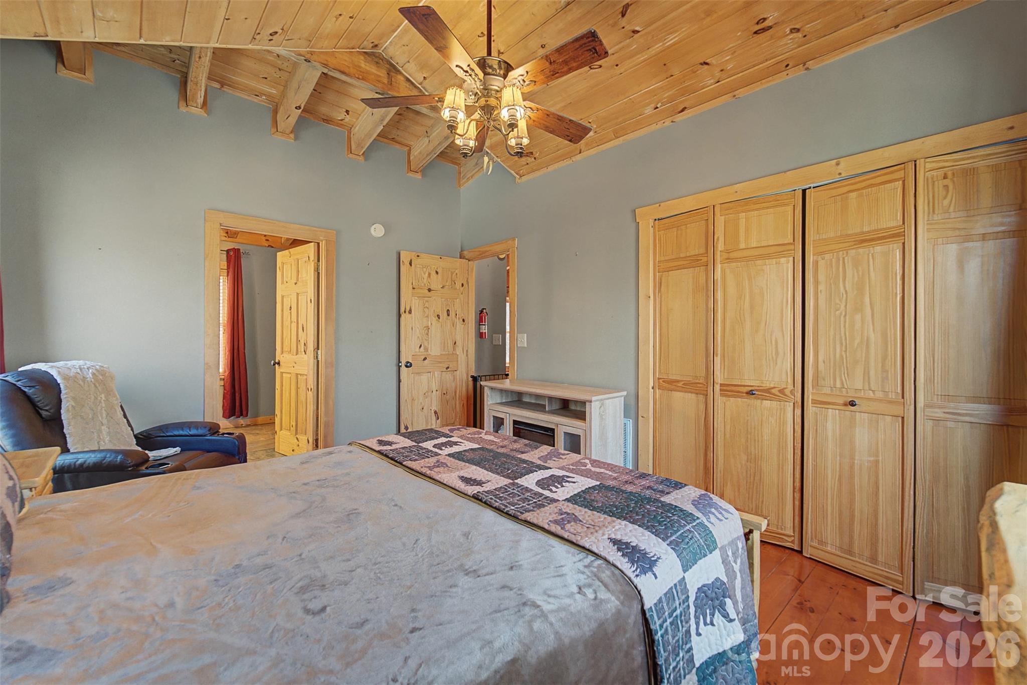 170 Wilkes Road Bryson City, NC 28713 - Photo 24 of 47 a bedroom with a large bed and chandelier