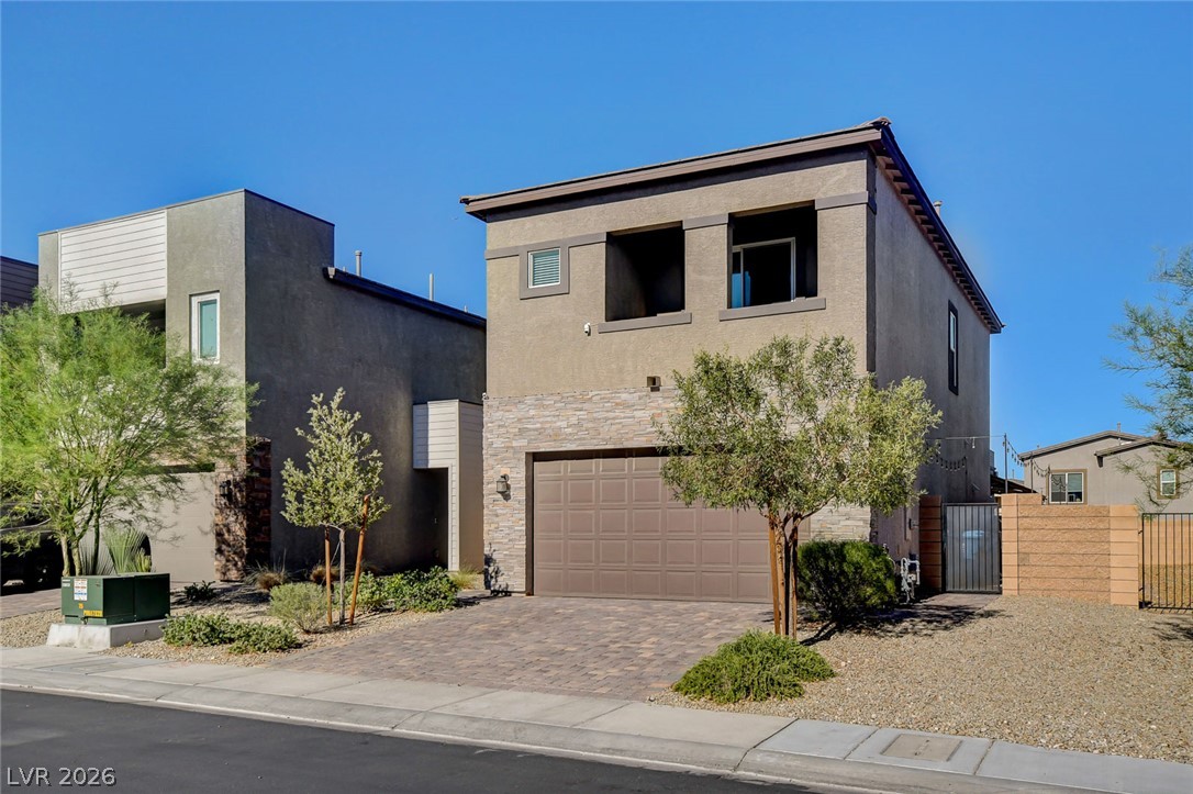 9688 Rankin Rdg Court Las Vegas, NV 89178 - Photo 3 of 53 Modern desert architecture with a paver driveway and subtle stone accents presents attractive curb appeal.