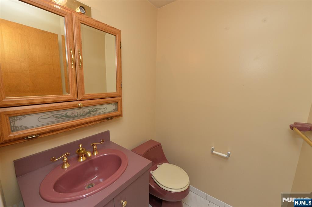 73 South Prospect Avenue Hackensack, NJ 07601 - Photo 11 of 28 a bathroom with a toilet a sink and mirror