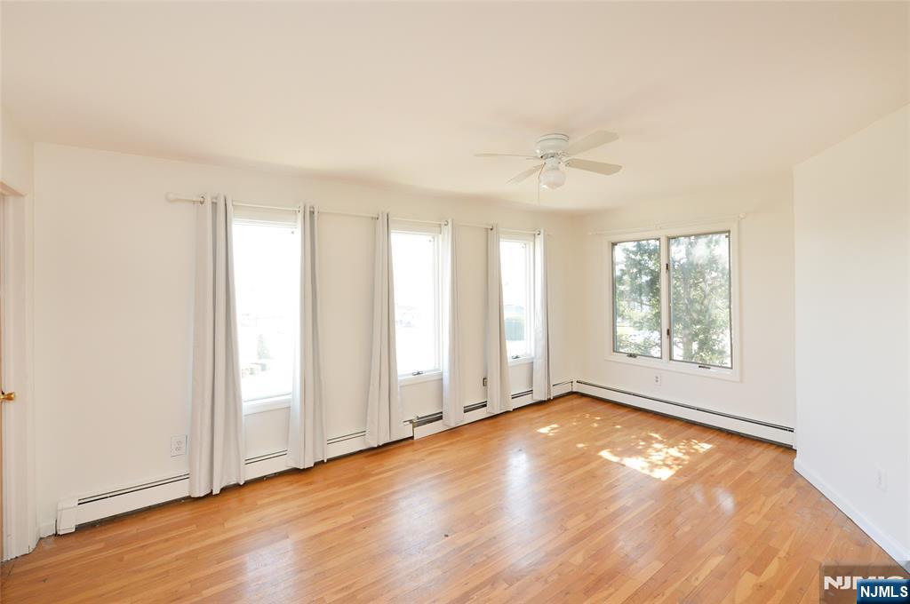 73 South Prospect Avenue Hackensack, NJ 07601 - Photo 13 of 28 an empty room with wooden floor and windows
