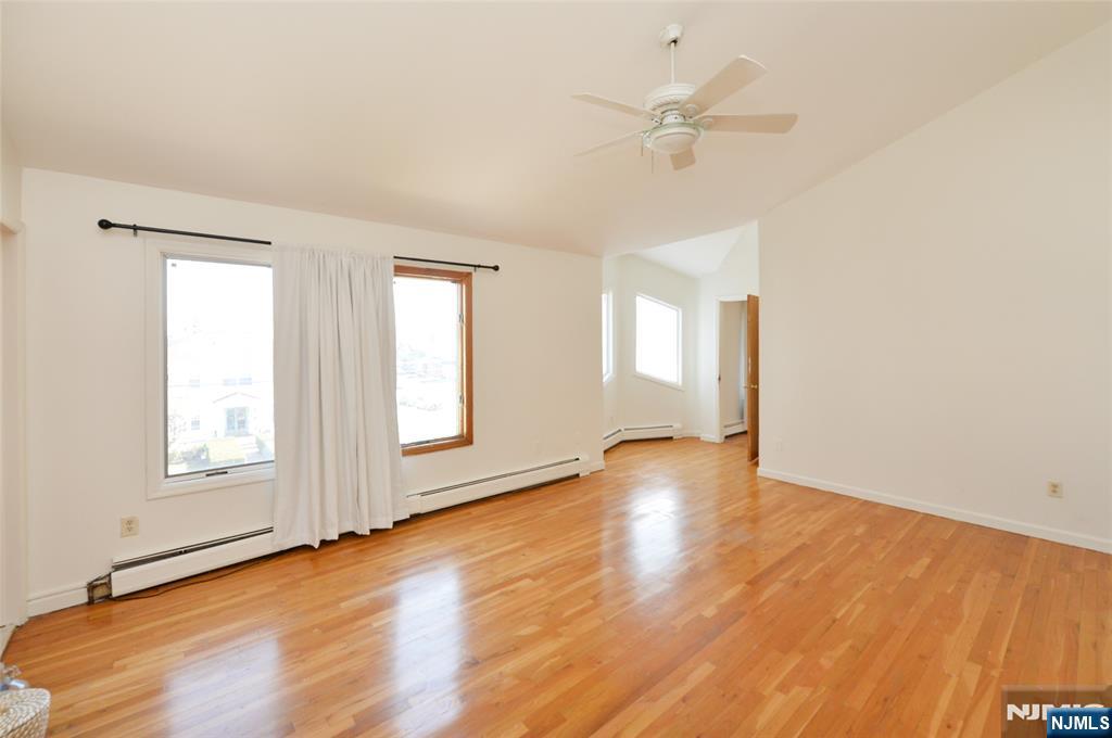 73 South Prospect Avenue Hackensack, NJ 07601 - Photo 19 of 28 an empty room with wooden floor fan and windows