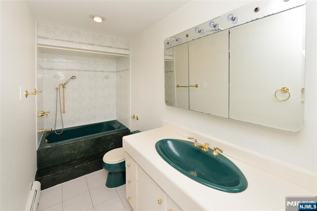 73 South Prospect Avenue Hackensack, NJ 07601 - Photo 20 of 28 a bathroom with a sink a toilet and shower