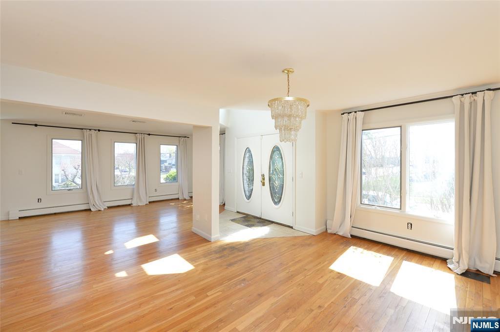 73 South Prospect Avenue Hackensack, NJ 07601 - Photo 2 of 28 a view of an empty room with glass door and wooden floor