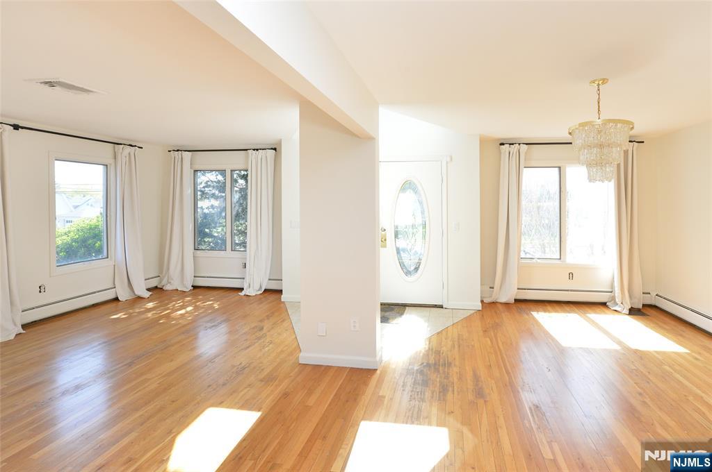 73 South Prospect Avenue Hackensack, NJ 07601 - Photo 3 of 28 an empty room with wooden floor and windows