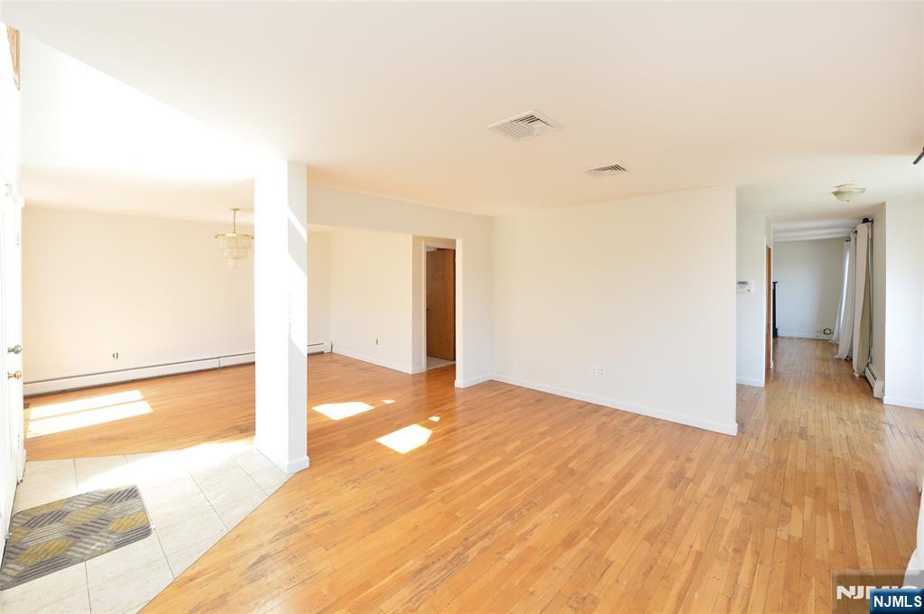 73 South Prospect Avenue Hackensack, NJ 07601 - Photo 4 of 28 a view of a room with wooden floor and a bathroom