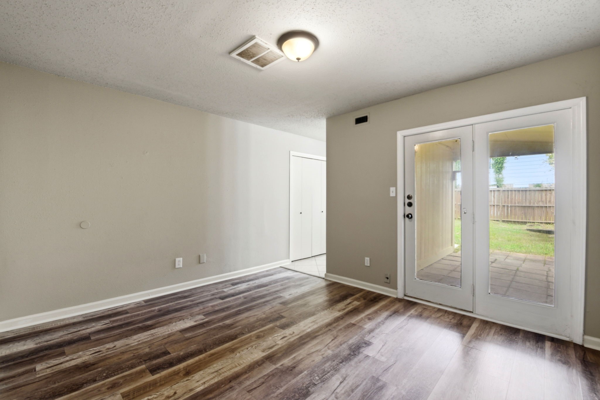 22910 Sherioaks Lane Spring, TX 77389 - Photo 14 of 27 an empty room with wooden floor and windows