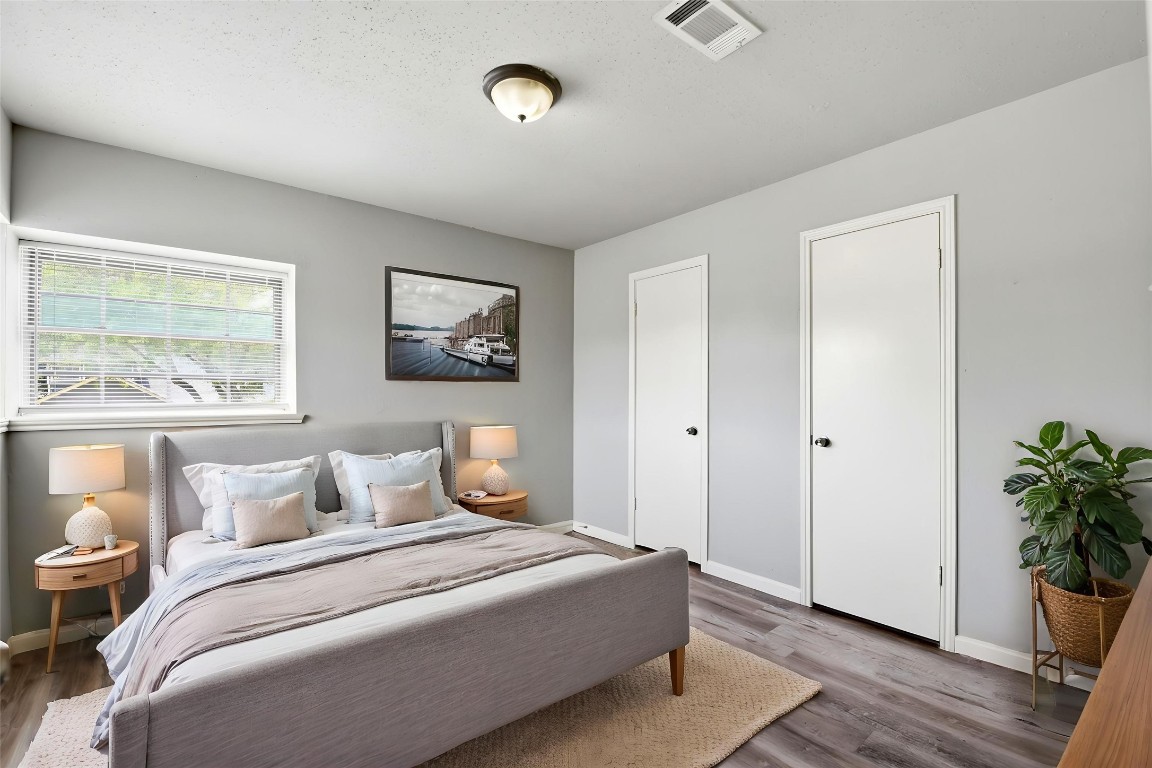 22910 Sherioaks Lane Spring, TX 77389 - Photo 17 of 27 a bedroom with a large bed and wooden floor