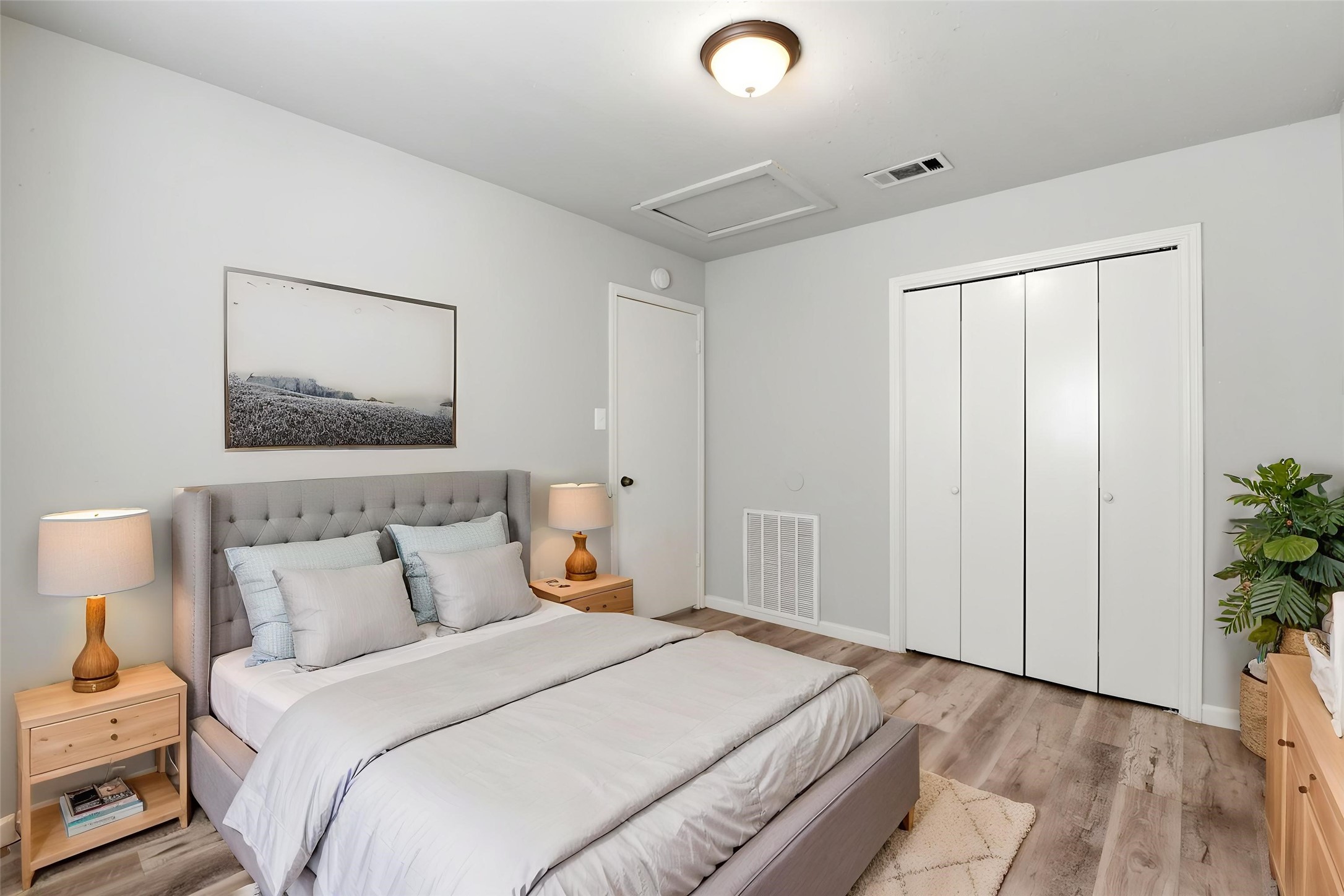 22910 Sherioaks Lane Spring, TX 77389 - Photo 19 of 27 a bedroom with a bed and a potted plant