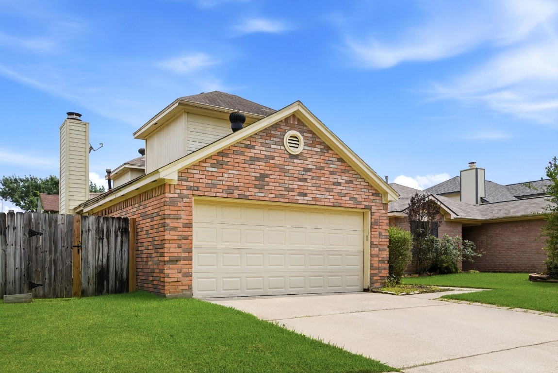 22910 Sherioaks Lane Spring, TX 77389 - Photo 2 of 27 a front view of a house with a yard and garage