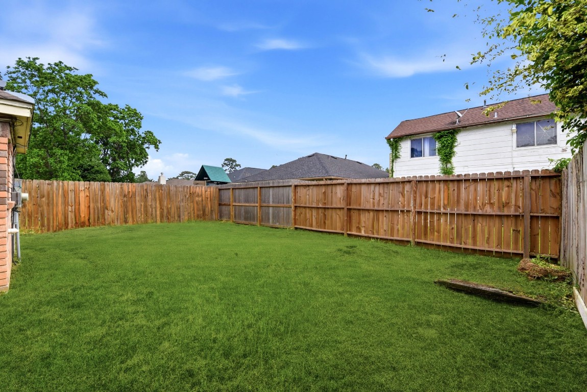 22910 Sherioaks Lane Spring, TX 77389 - Photo 25 of 27 a view of backyard with wooden fence